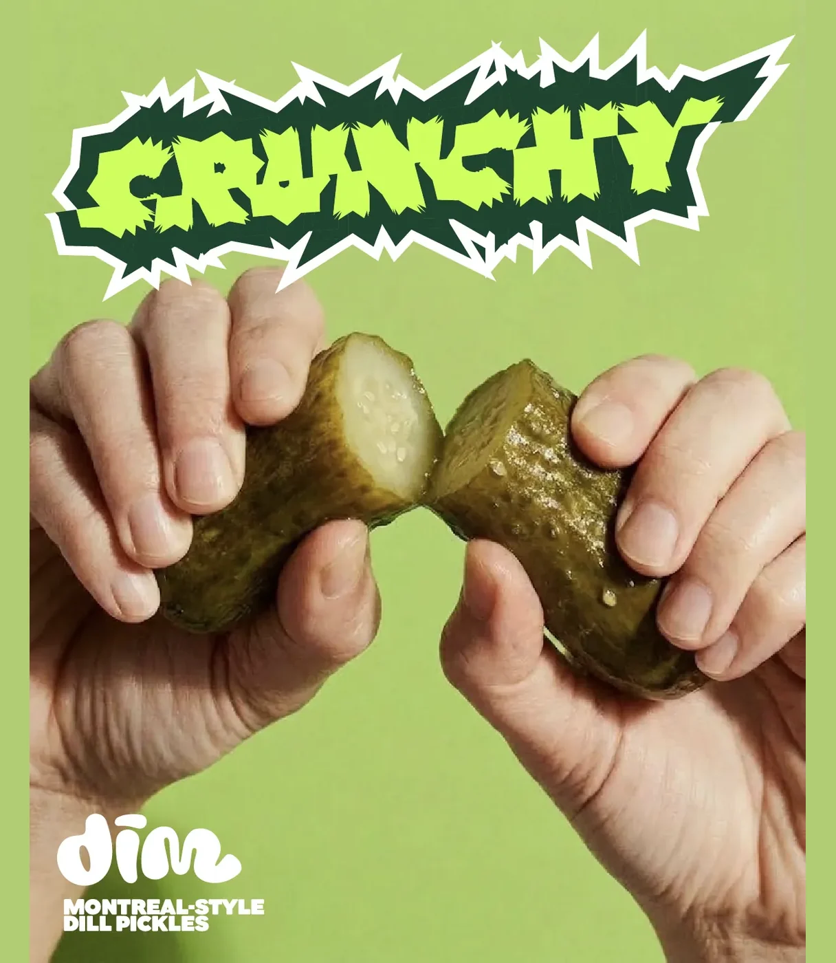 Crunchy poster: two hands snapping a pickle in half