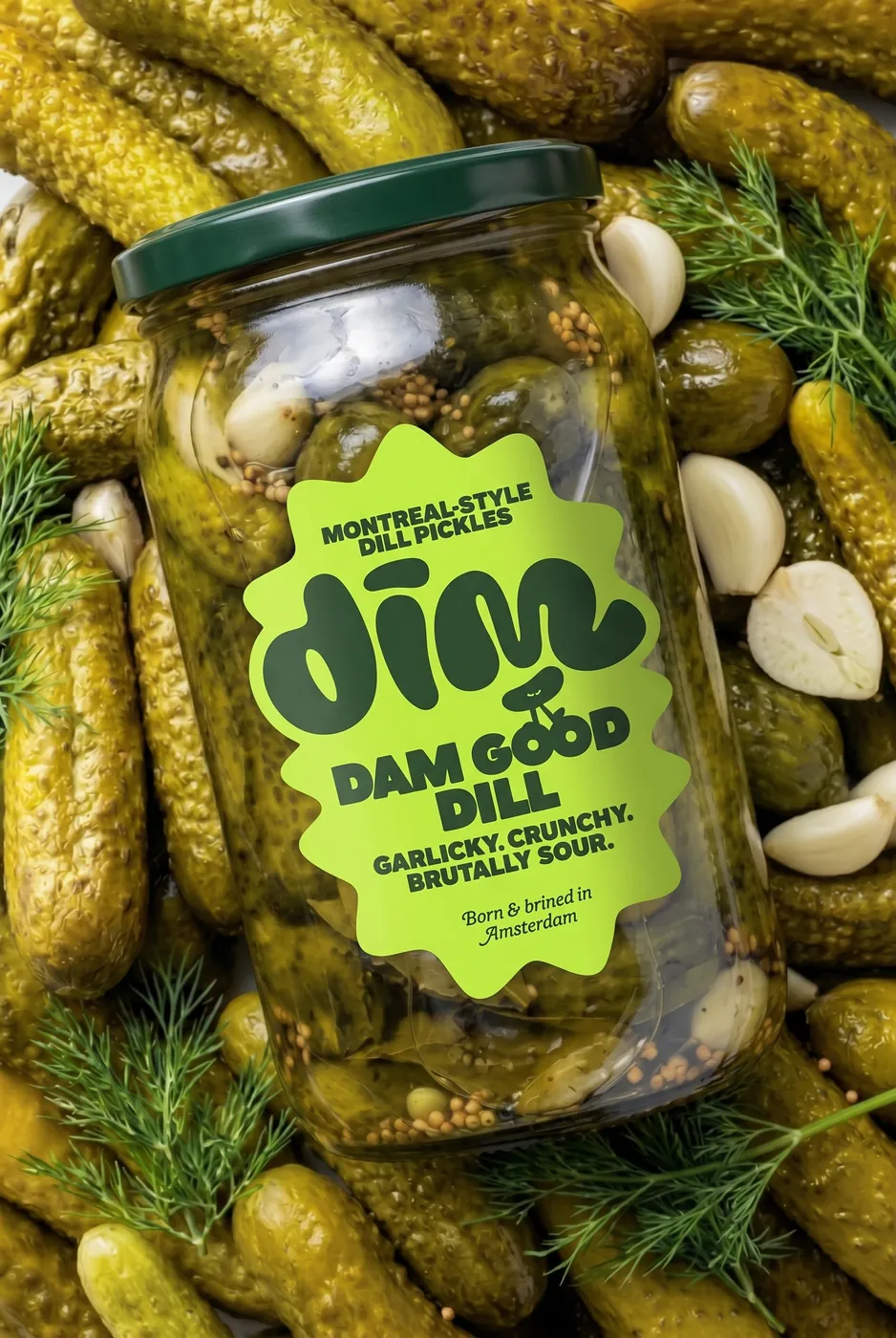Dim Pickles jar lying on a bed of pickles, garlic and dill