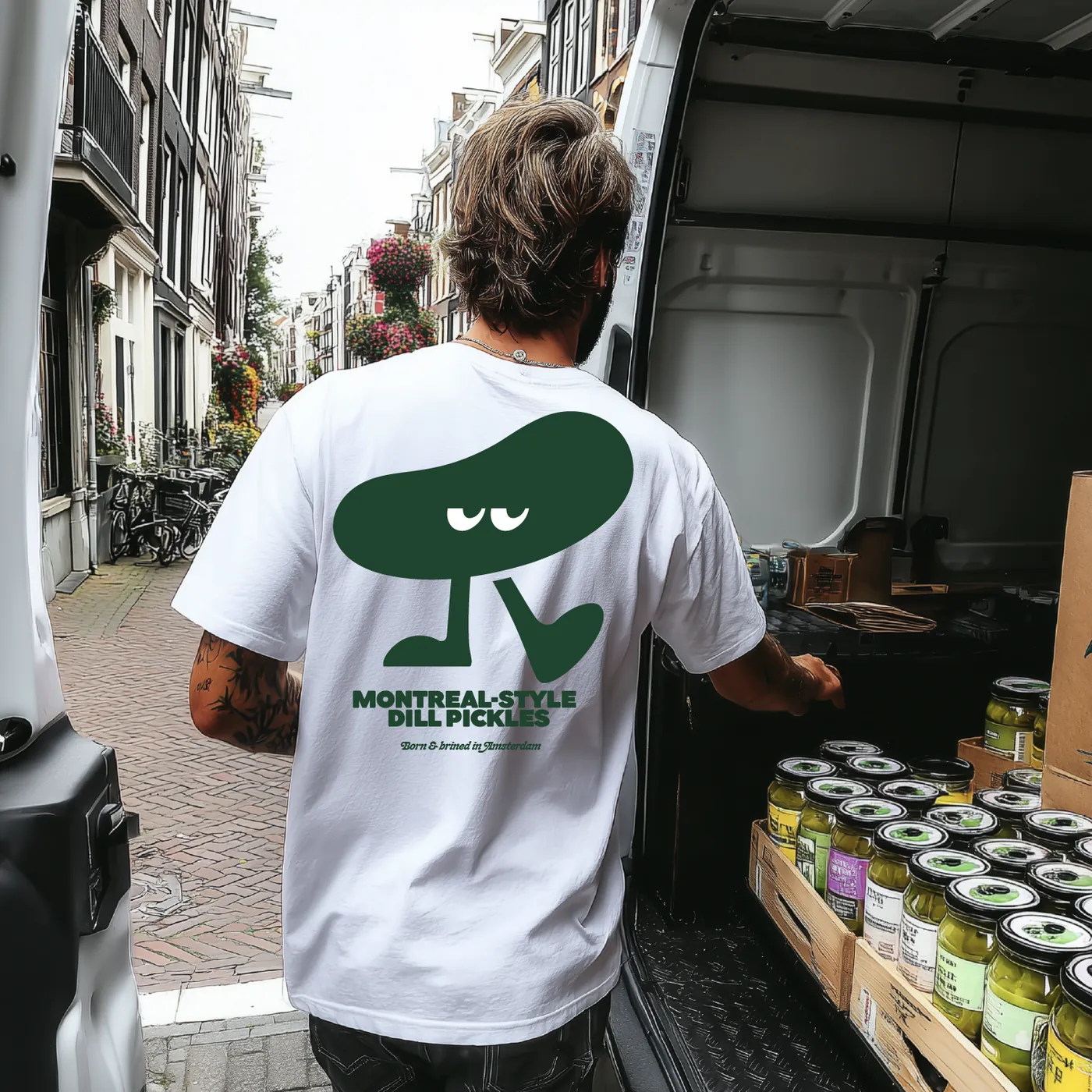 Man in a Dim Pickles t-shirt unloading jars from a van in Amsterdam