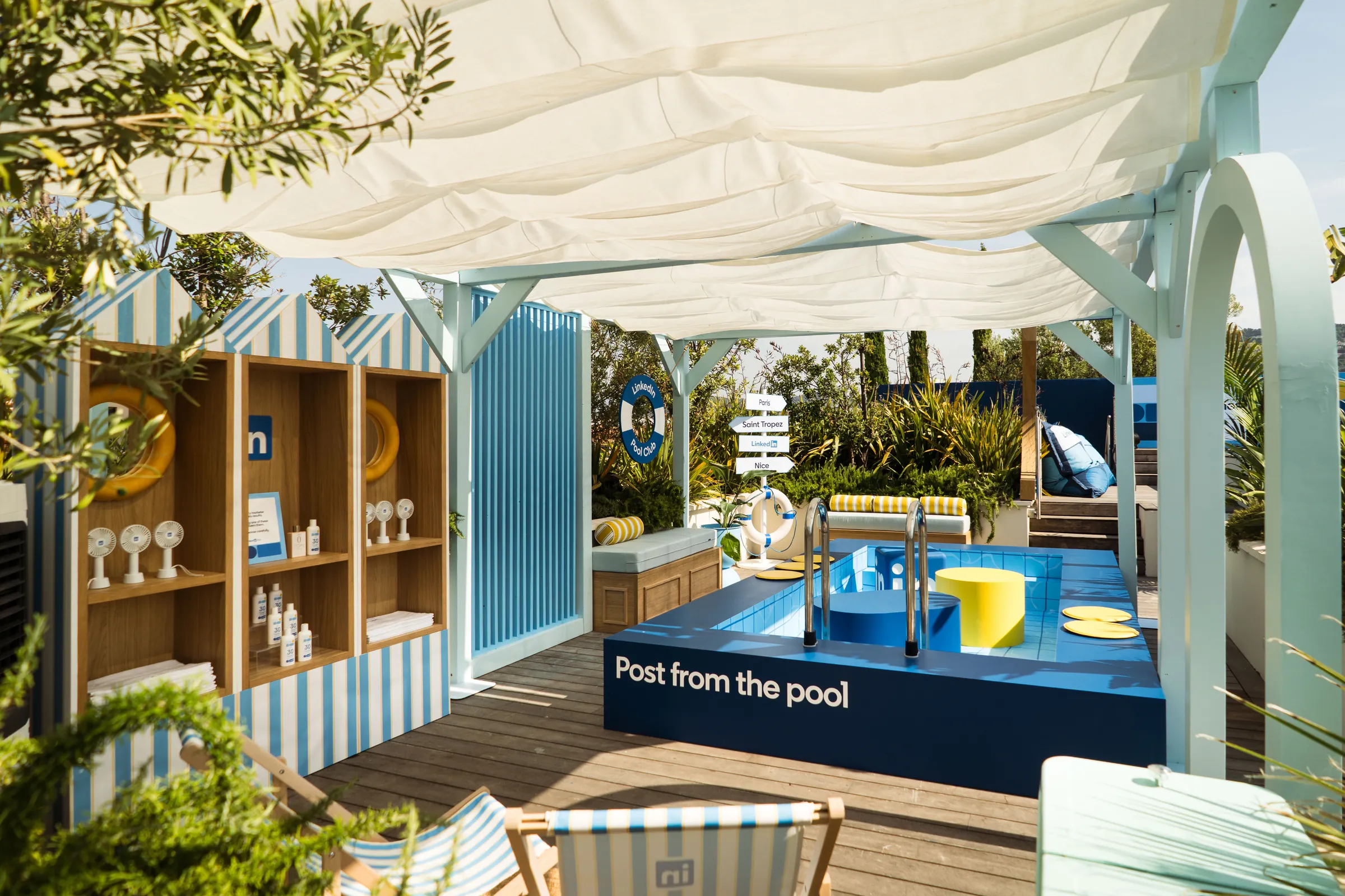 “Post from the pool” lounge with striped canopy and pool