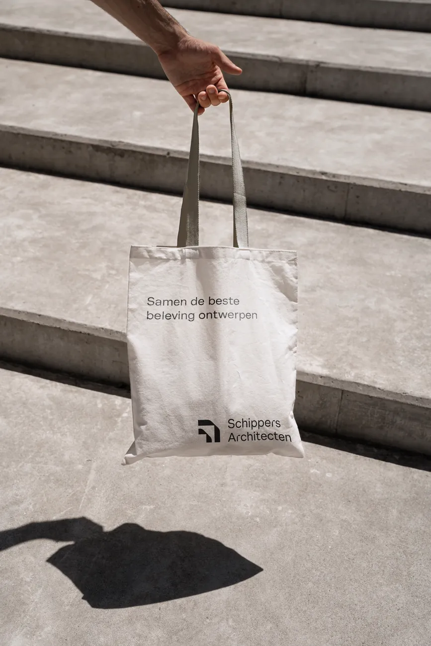 Tote bag held above concrete steps