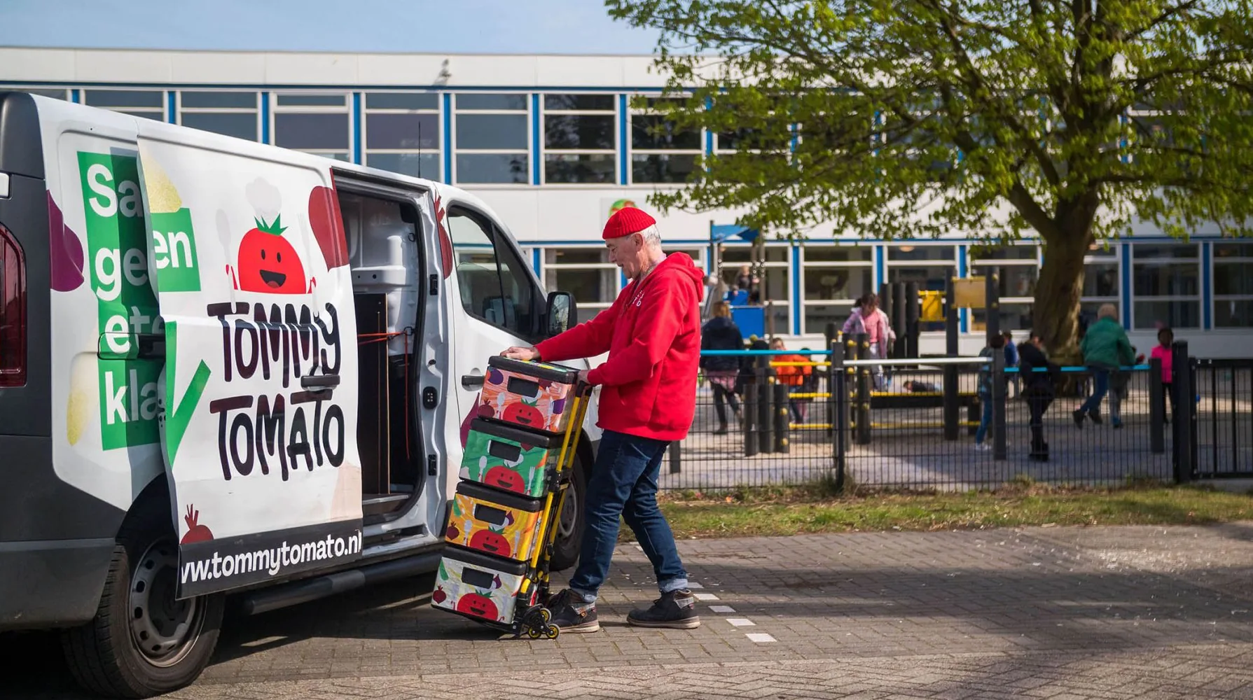 TommyTomato van at a primary school, boxes loaded on a trolley